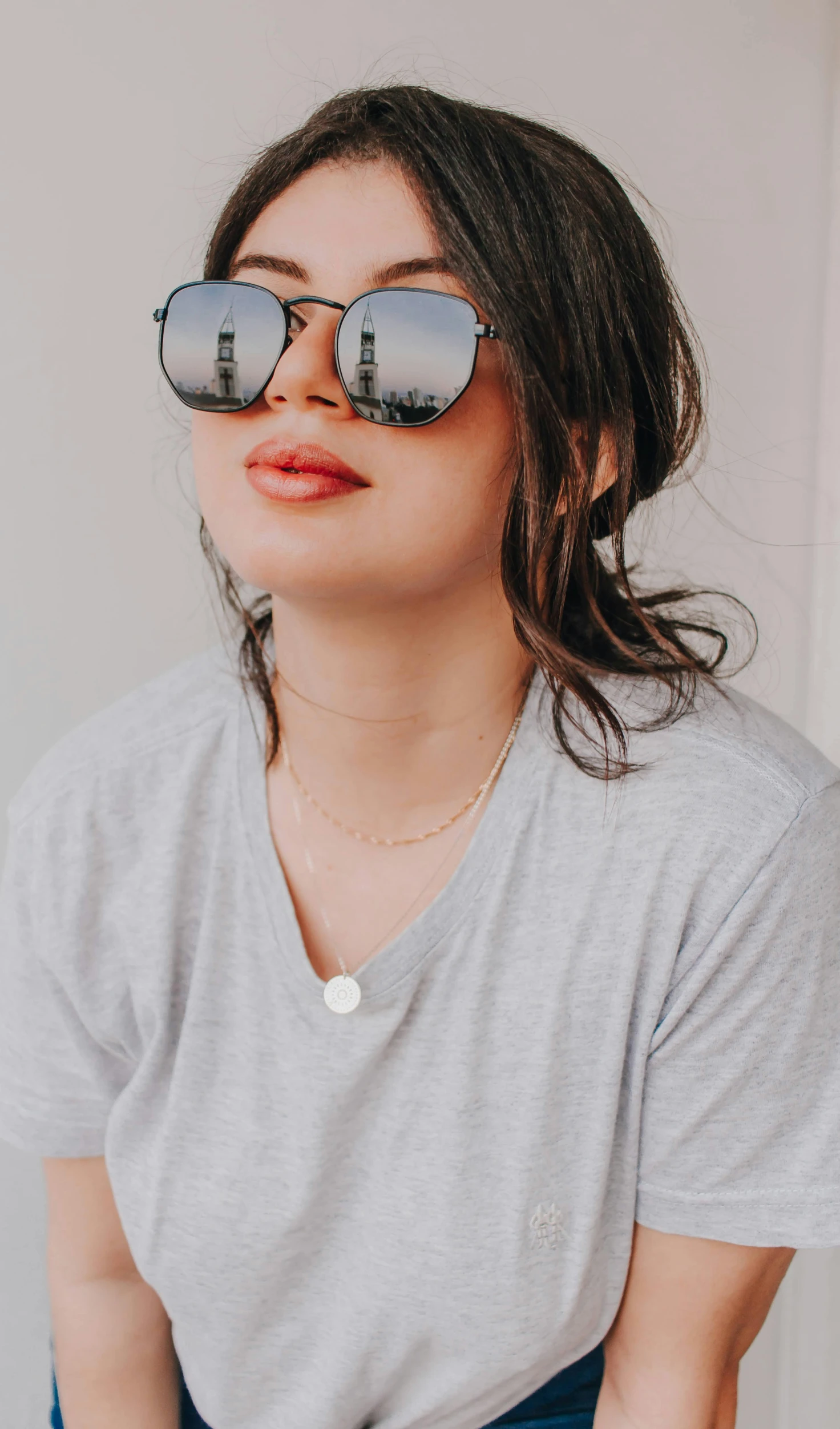 a woman wearing sunglasses and a grey shirt, inspired by Ruth Jên, trending on pexels, low quality photo, concept photo