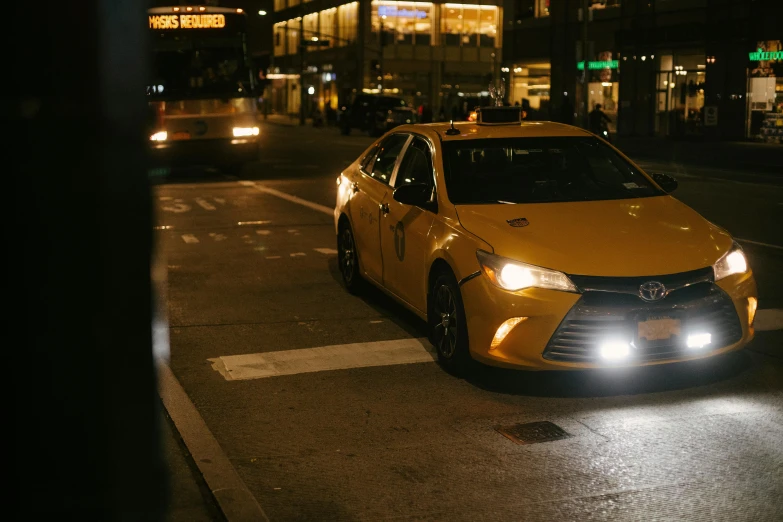 a yellow car on a city street at night, humans of new york, fan favorite, medium shot angle, ambient lighting