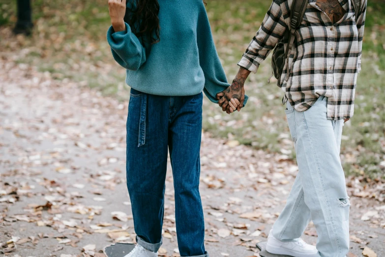 a couple of people standing on top of a skateboard, trending on pexels, wearing teal beanie, hands pressed together in bow, walking at the garden, baggy jeans