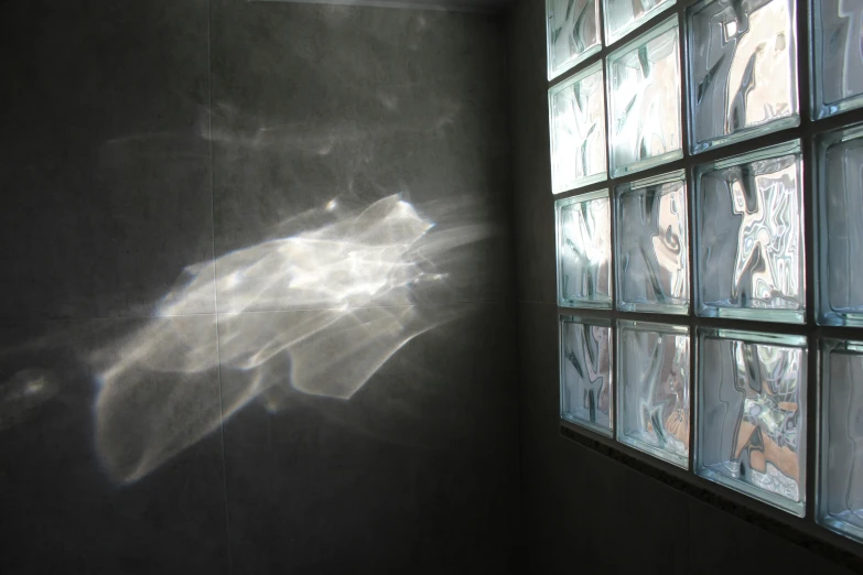 a sun shines through a window in a dark room, a hologram, inspired by Anna Füssli, light and space, water running down the walls, cast glass, silver light, white light