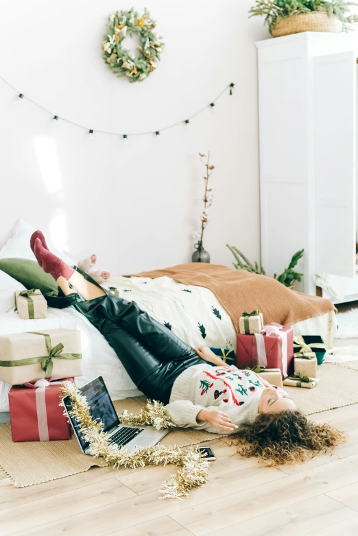 a woman laying on the floor surrounded by presents, by Julia Pishtar, trending on pexels, happening, fullbody photo, low fi, gif