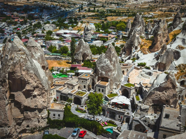 an aerial view of the town of cappadin in cappadin national park, cappadin national park, cappadin national park, pexels contest winner, art nouveau, cozy bathhouse hidden in a cave, 1990's photo, asymmetrical spires, post-processed