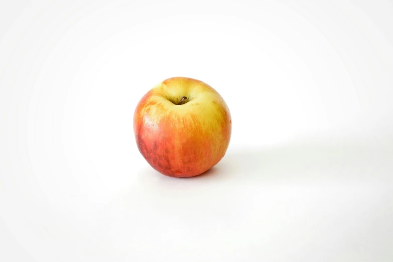 a red apple sitting on top of a white surface, light tan, f / 2 0, fan favorite, small in size