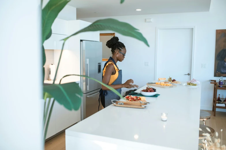 a woman standing in a kitchen preparing food, by Daniel Lieske, pexels contest winner, lupita nyong'o, avatar image, open plan, profile image