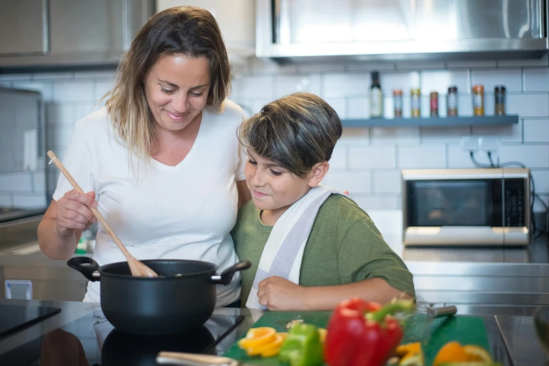 a woman and a child cooking in a kitchen, pexels contest winner, avatar image, fan favorite, pots and pans, food commercial 4 k