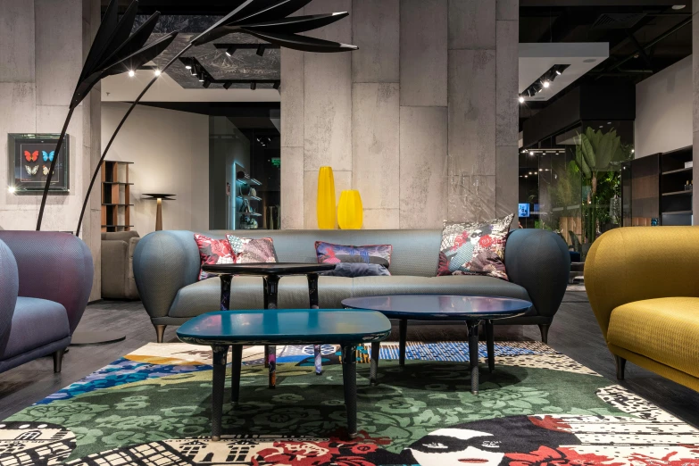 a living room filled with lots of colorful furniture, inspired by Emilio Grau Sala, unsplash, rosenthal, show room scene, concrete hitech interior, dezeen showroom