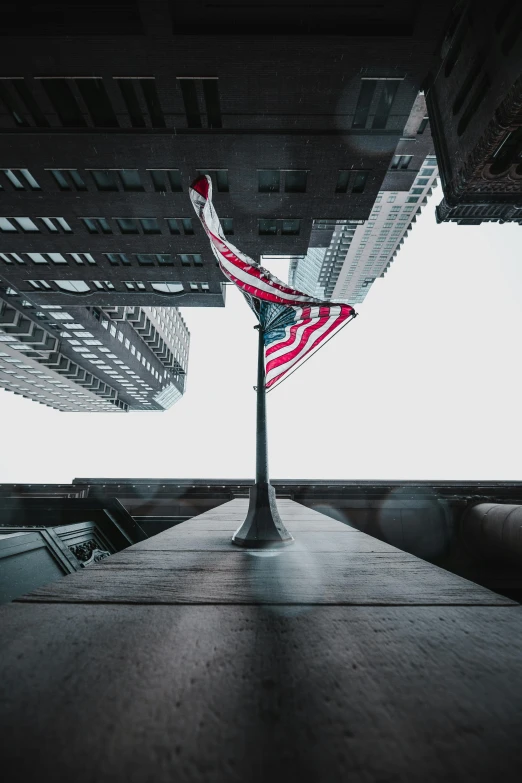 an american flag flying on top of a building, a picture, by Andrew Domachowski, unsplash contest winner, centered portrait, wall street, 8k resolution”, low ultrawide shot