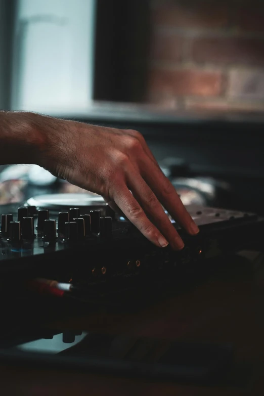 a close up of a person using a dj controller, by Robbie Trevino, private press, high quality image, alessio albi, **cinematic, silky smooth