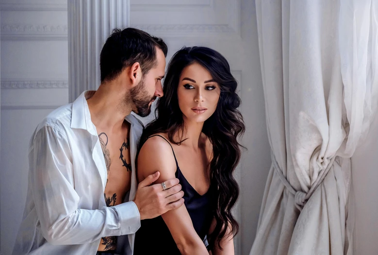 a man and a woman standing next to each other, a tattoo, by Zofia Stryjenska, pexels contest winner, romanticism, brunette woman, in a bedroom, handsome girl, meni chatzipanagiotou