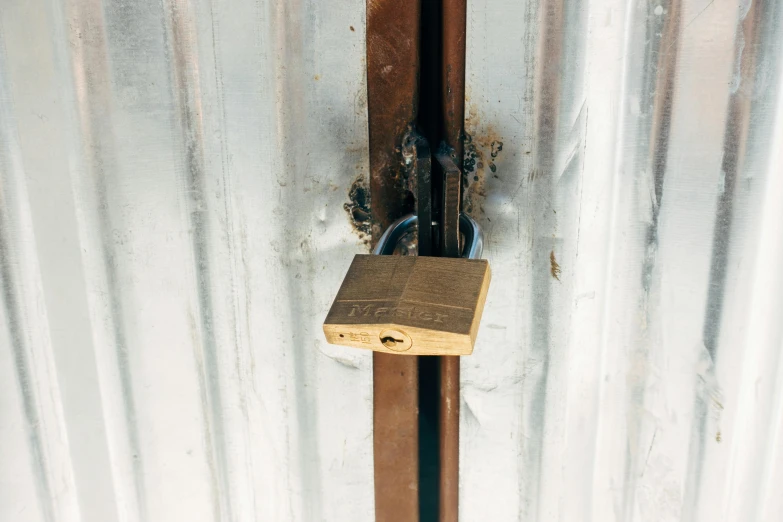 a close up of a padlock on a metal door, an album cover, unsplash, private press, brown, inside a shed, 4 0 9 6, ice gate