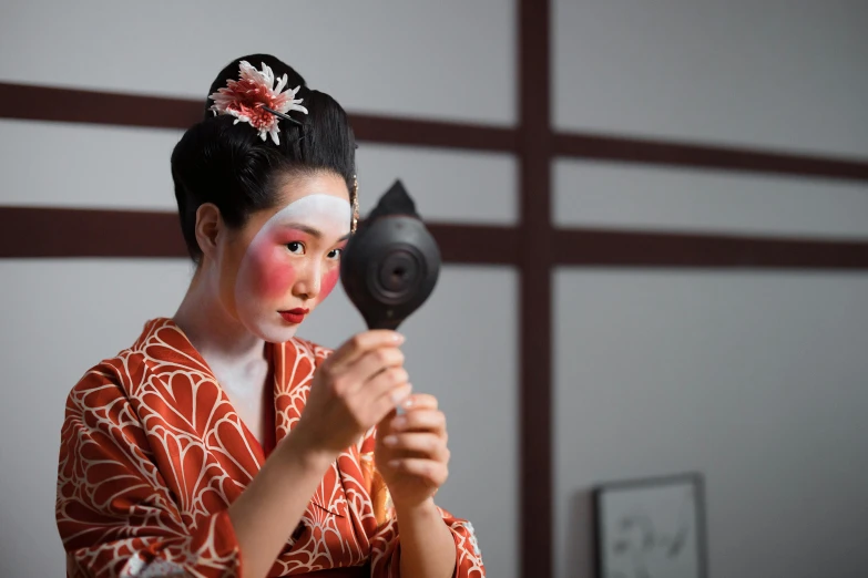 a woman in a kimono holding a hair dryer, a portrait, pexels contest winner, noh theatre mask, square, bodypaint, looking in mirror