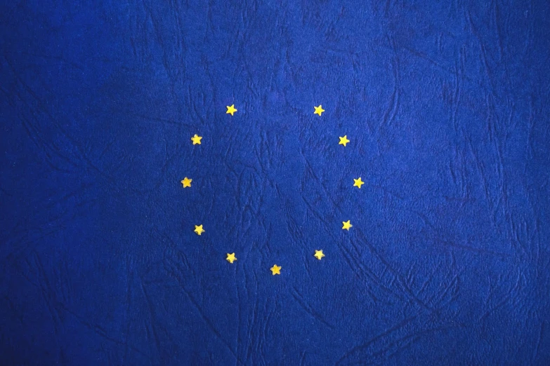 the flag of the european union on a blue background, an album cover, pexels, excessivism, circular, annie leibowit, old skin, thumbnail