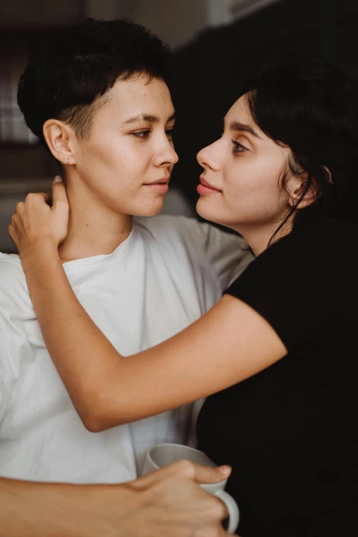 a couple of women standing next to each other, trending on pexels, antipodeans, lesbian embrace, woman with black hair, genderless, 15081959 21121991 01012000 4k