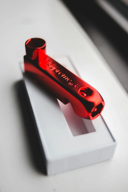 a red lighter sitting on top of a white box, beeple and james jean, wrench, award winning engraving, splento