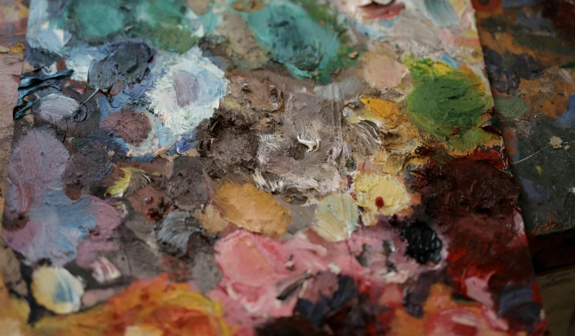 a close up of a palette on a table, inspired by Vincenzo Irolli, analytical art, google arts and cultures, brown, multicoloured, close-ups