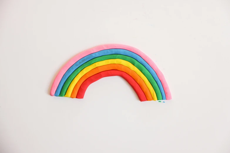 a close up of a rainbow on a white surface, by Nicolette Macnamara, made out of clay, made of fabric, product view, ryden