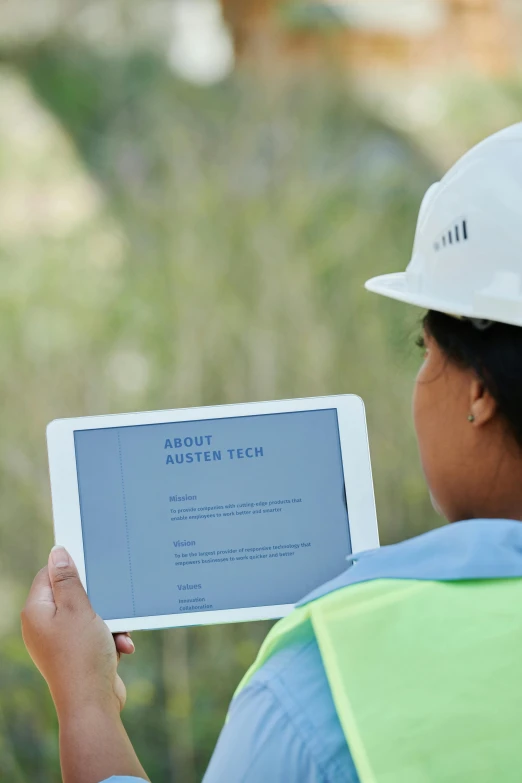 a woman in a hard hat holding a tablet, a picture, by Jan Rustem, unsplash, 2 5 6 x 2 5 6 pixels, tech demo, zoomed in, asher duran