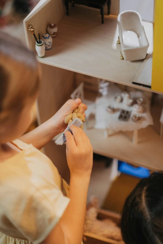 two children are playing with a doll house, pexels contest winner, process art, high angle close up shot, inspect in inventory image, thumbnail, snacks