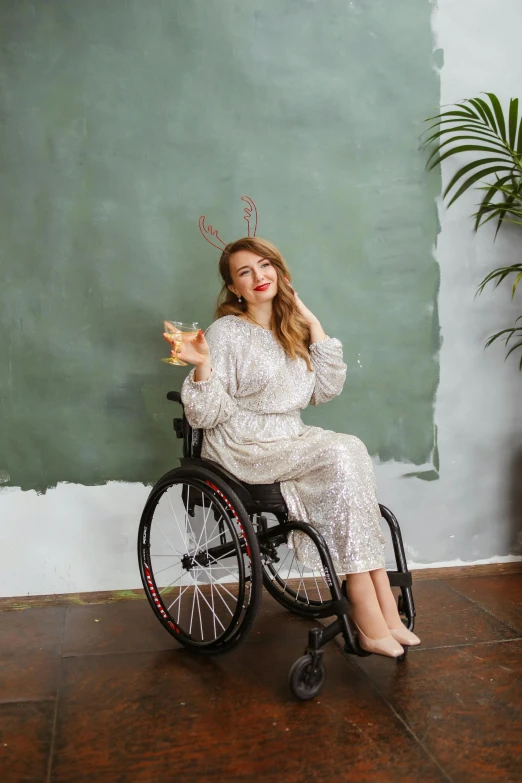 a woman in a wheelchair posing for a picture, by Julia Pishtar, trending on pexels, renaissance, wearing white pajamas, young woman with antlers, wearing a cocktail dress, pudica pose gesture