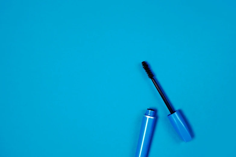 a close up of a mascara on a blue surface, blue themed, lacquered, on a canva, feature