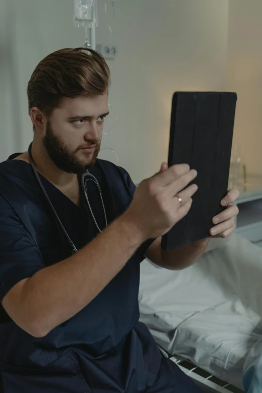 a man sitting on a hospital bed looking at a tablet, trending on reddit, happening, ( ( theatrical ) ), doctors mirror, mrbeast, vhs style