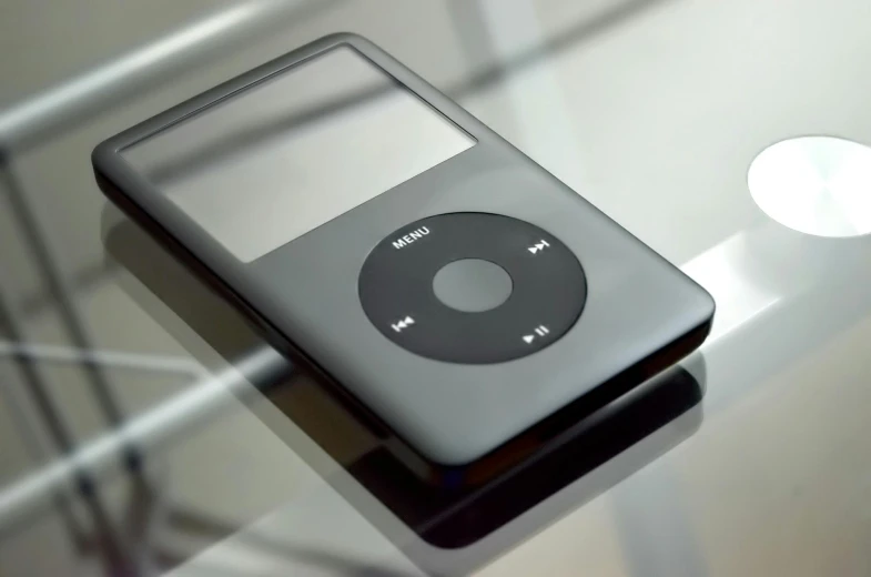 an ipod sitting on top of a glass table, by Joe Stefanelli, pexels, renaissance, realistic footage, steel gray body, black, circular