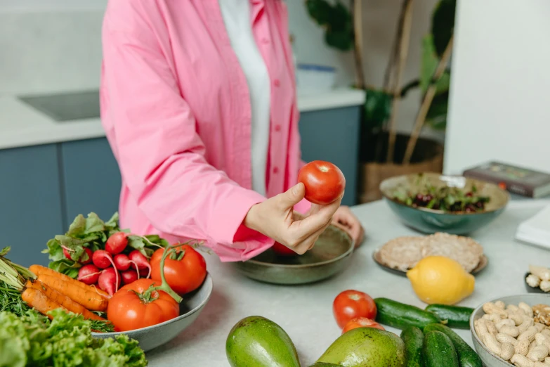 a woman in a pink shirt is holding a tomato, pexels contest winner, strange ingredients on the table, avatar image, profile image, head to waist