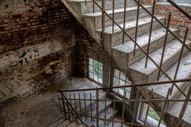 a set of stairs in a building with graffiti on the walls, inspired by Elsa Bleda, pexels contest winner, crumbling masonry, promo image, observation deck, brick