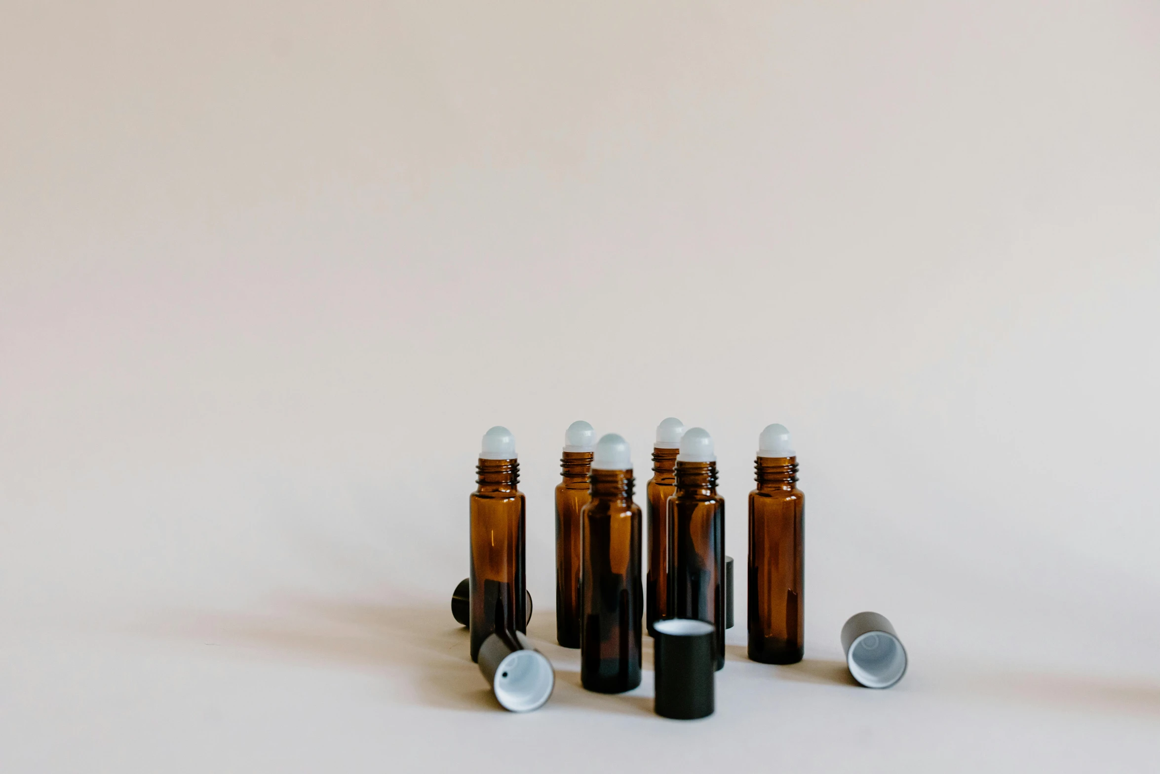 a group of bottles sitting next to each other on a white surface, a picture, well list, amber, blind, product view