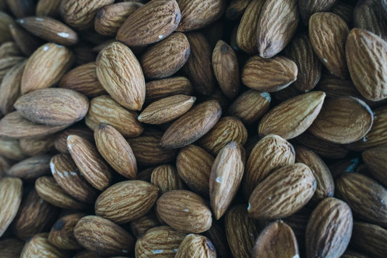 a pile of almonds sitting on top of each other, by Carey Morris, pexels, a high angle shot, no cropping, thumbnail, 1 9 7 0 s photo