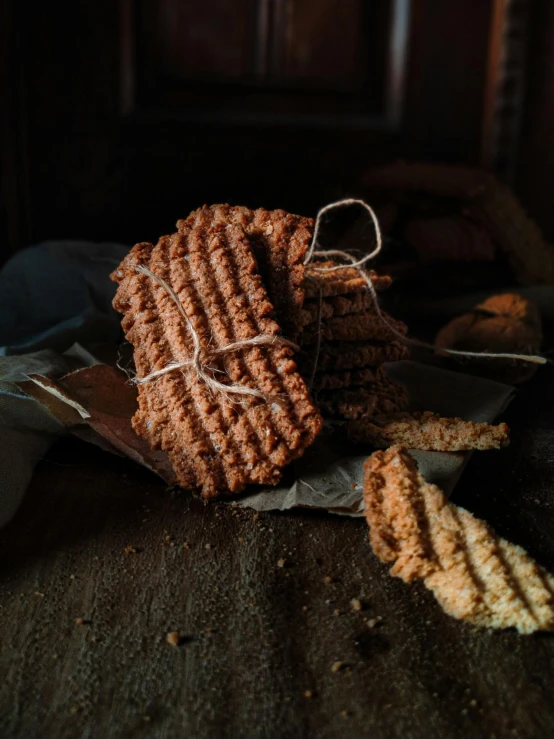 a pile of cookies sitting on top of a table, a portrait, by Aleksander Gierymski, pexels, renaissance, woven with electricity, medium format. soft light, bricks, indoor picture