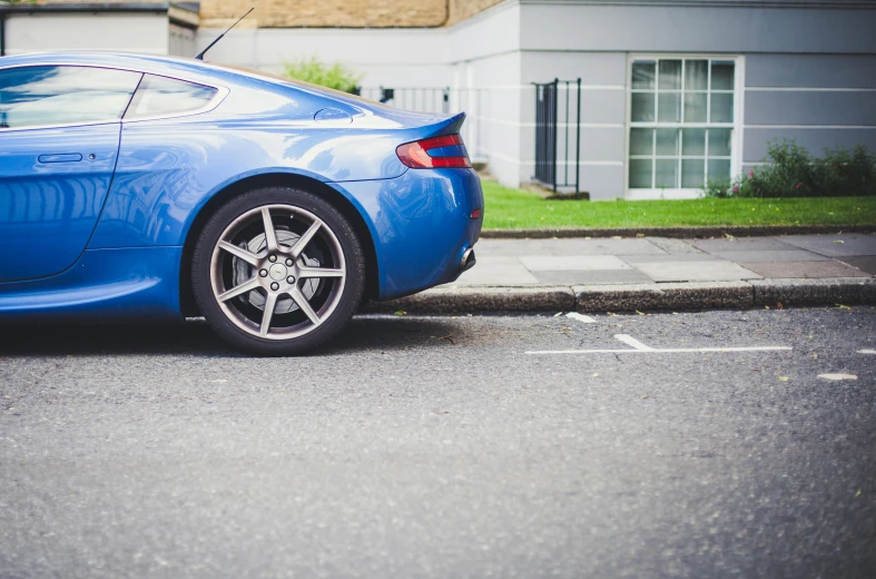 a blue sports car parked on the side of the road, by Tom Bonson, pexels contest winner, parking in the street, thick tail, eight eight eight, best practice