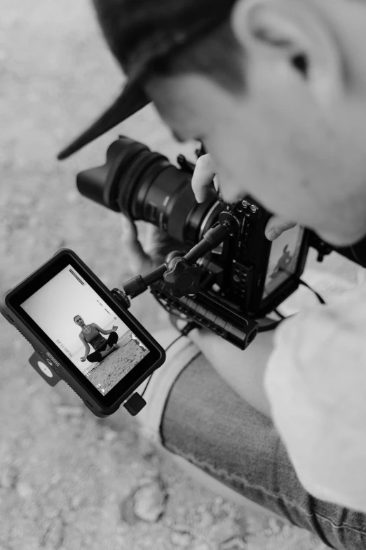 a black and white photo of a man holding a camera, unsplash, video art, professional digital edit, behind the scenes, action photograph, photograph from above