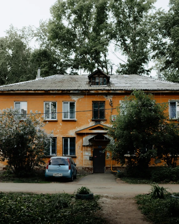 a house with a car parked in front of it, inspired by Isaac Levitan, pexels contest winner, danube school, vibrant but dreary orange, soviet yard, 000 — википедия, yellow and olive color scheme