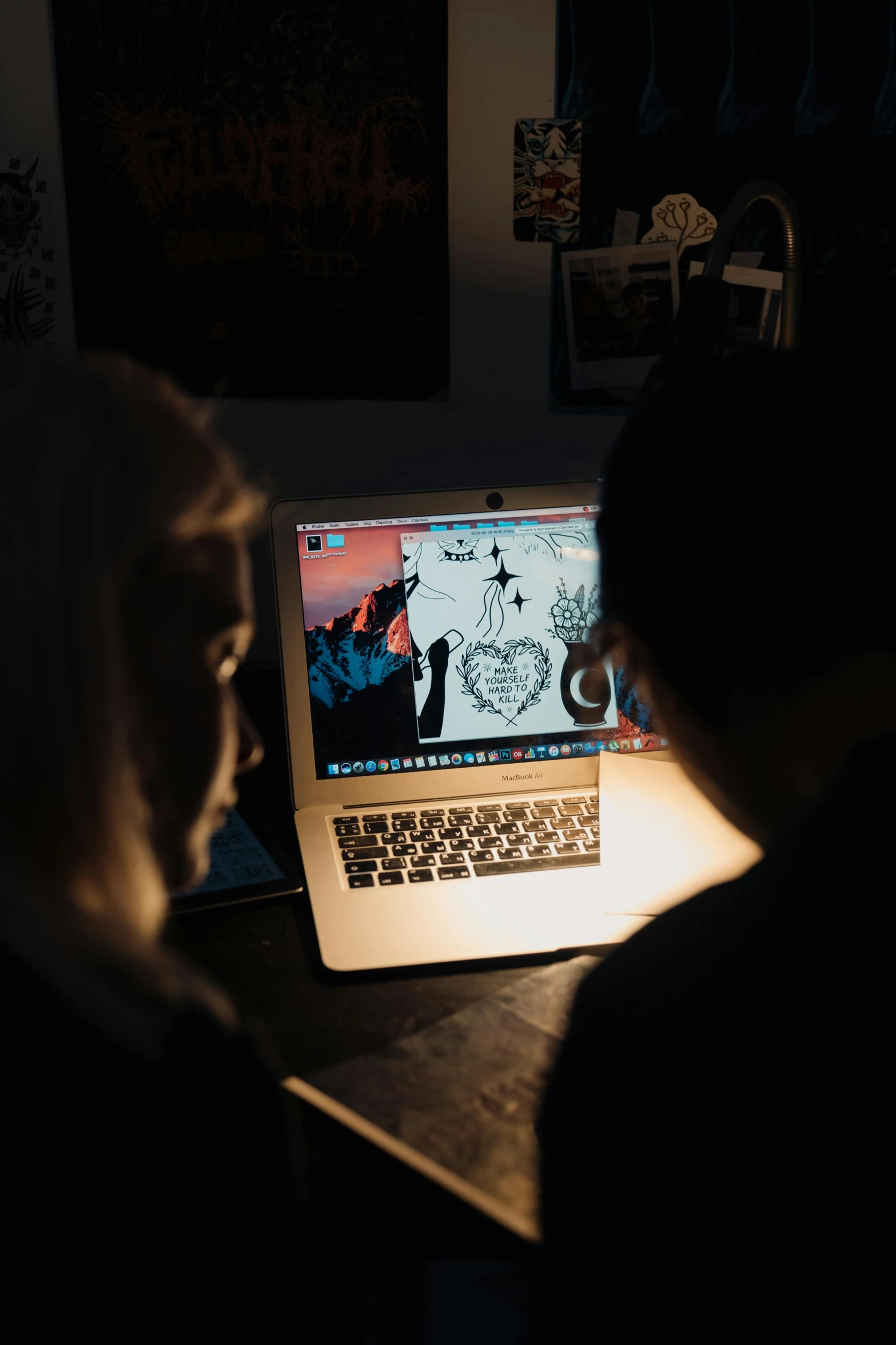 a person sitting in front of a laptop computer, by Julia Pishtar, pexels contest winner, computer art, medium shot of two characters, lit from behind, heart of the internet, in a workshop