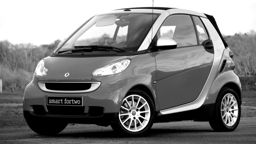 a black and white photo of a smart car, grey and silver, square, high res photograph, widescreen