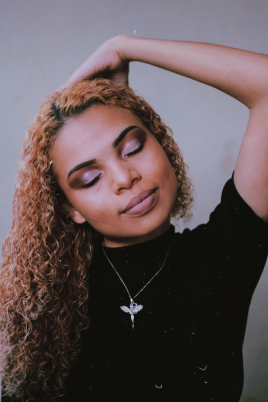 a woman with curly hair posing for a picture, an album cover, inspired by Theo Constanté, trending on pexels, hurufiyya, light gold hair, arm around her neck, full makup, violet myers