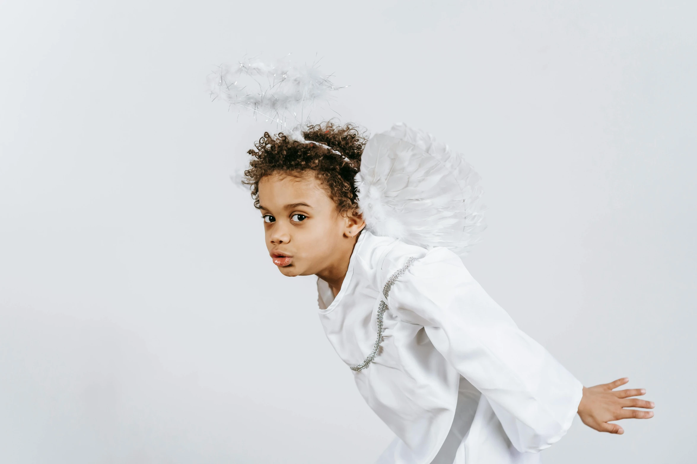 a little girl dressed as an angel flying through the air, pexels contest winner, portrait willow smith, 'white background'!!!, dafne keen, young boy