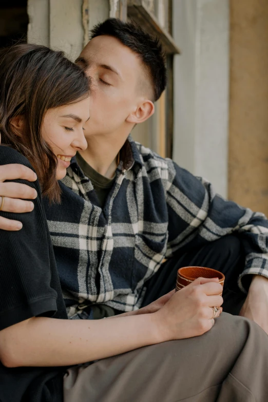 a man and a woman sitting next to each other, trending on pexels, hugging, drinking a coffee, boy and girl, lightly dressed