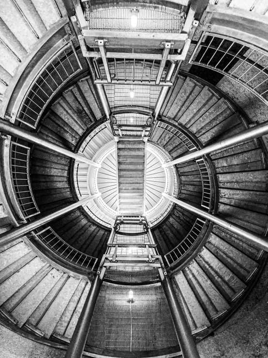 a black and white photo of a spiral staircase, by Kristian Kreković, metal towers and sewers, symmetry concpet art, watertank, symmetrical rim light