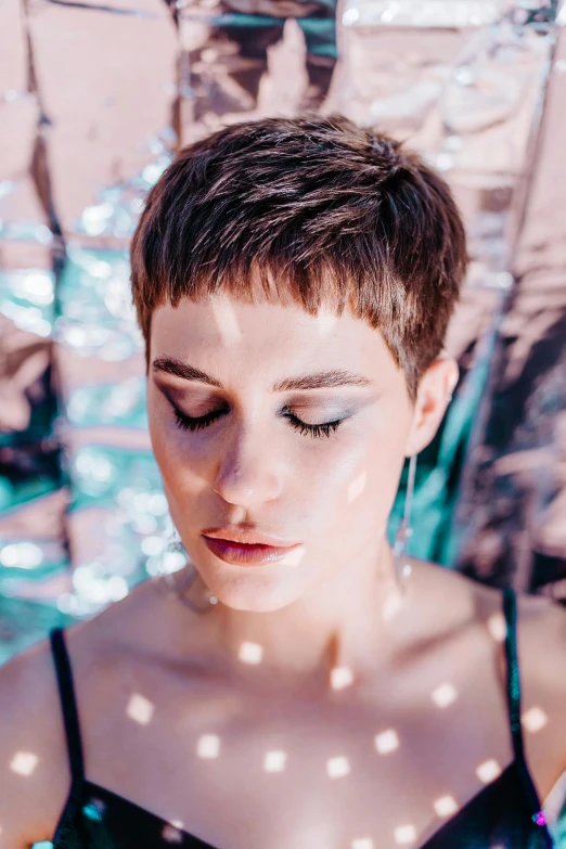 a woman standing under an umbrella in a pool, an album cover, inspired by Elsa Bleda, trending on pexels, pixie cut with shaved side hair, close up portrait photo, concert, amy sol in the style of