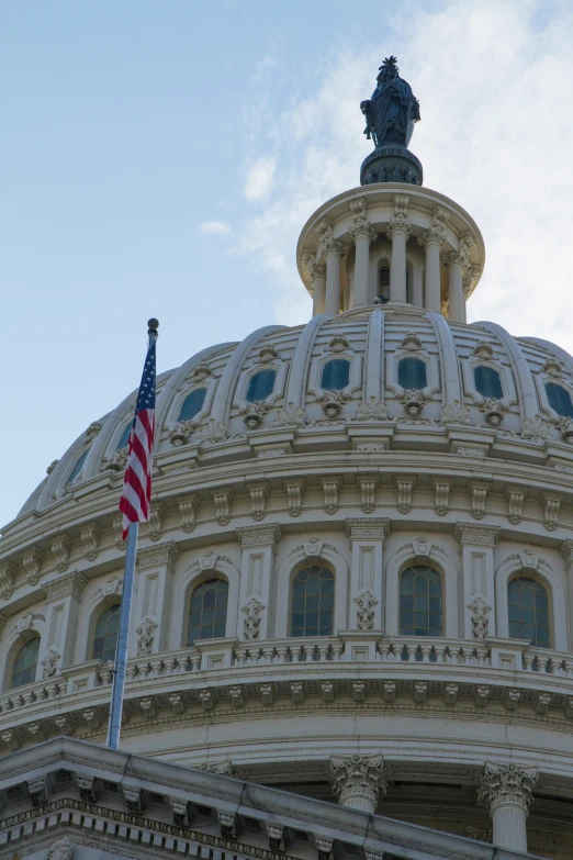 the dome of the us capitol building with an american flag flying in front of it, slide show, best photo