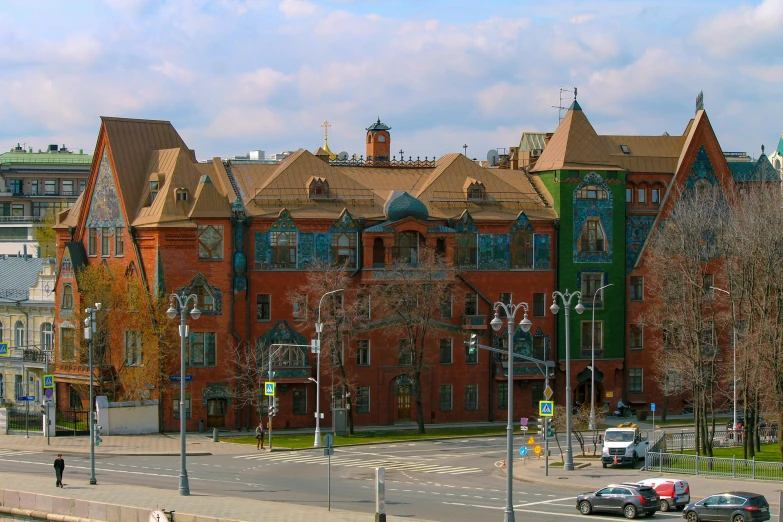 a large red brick building sitting on the side of a road, a photo, inspired by Nikolay Makovsky, art nouveau, 000 — википедия, multi - coloured, vasnetsov, square