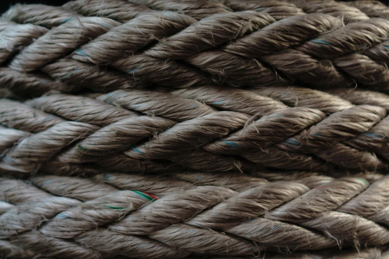 a pile of rope sitting on top of a table, an album cover, pexels, detail texture, carbon fibers, brown, detailed photo 8 k