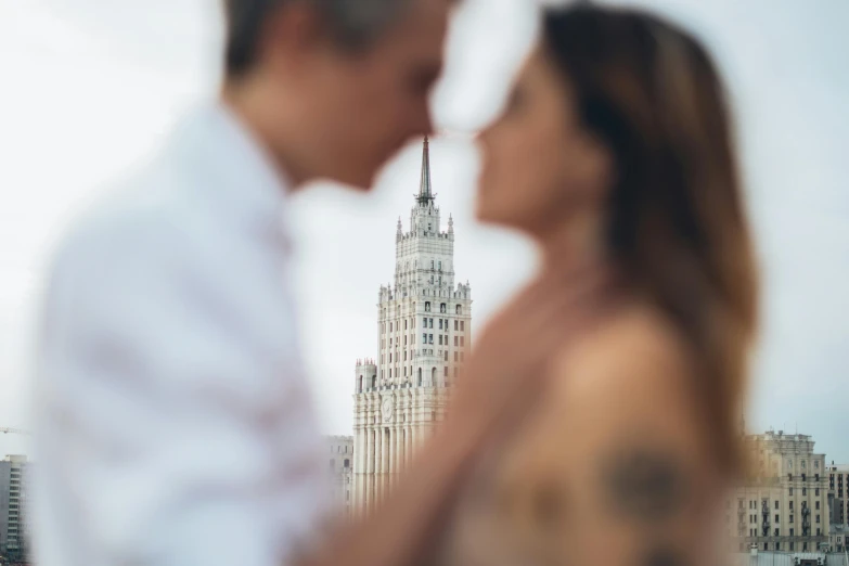 a man and a woman standing next to each other, a picture, by Emma Andijewska, pexels contest winner, socialist realism, skyscrapers in the background, russia, no blur dof bokeh, album cover