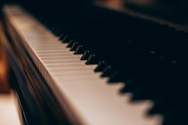 a close up of the keys of a piano, an album cover, pexels, muted lighting, deep colour, brown, low lighting