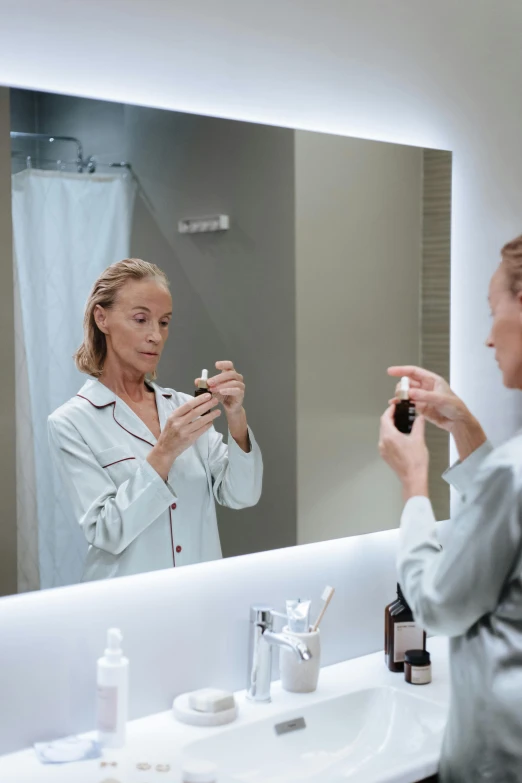 a woman brushing her teeth in front of a mirror, by Dietmar Damerau, happening, wearing nanotech honeycomb robe, goodnight, profile image, 5 5 yo