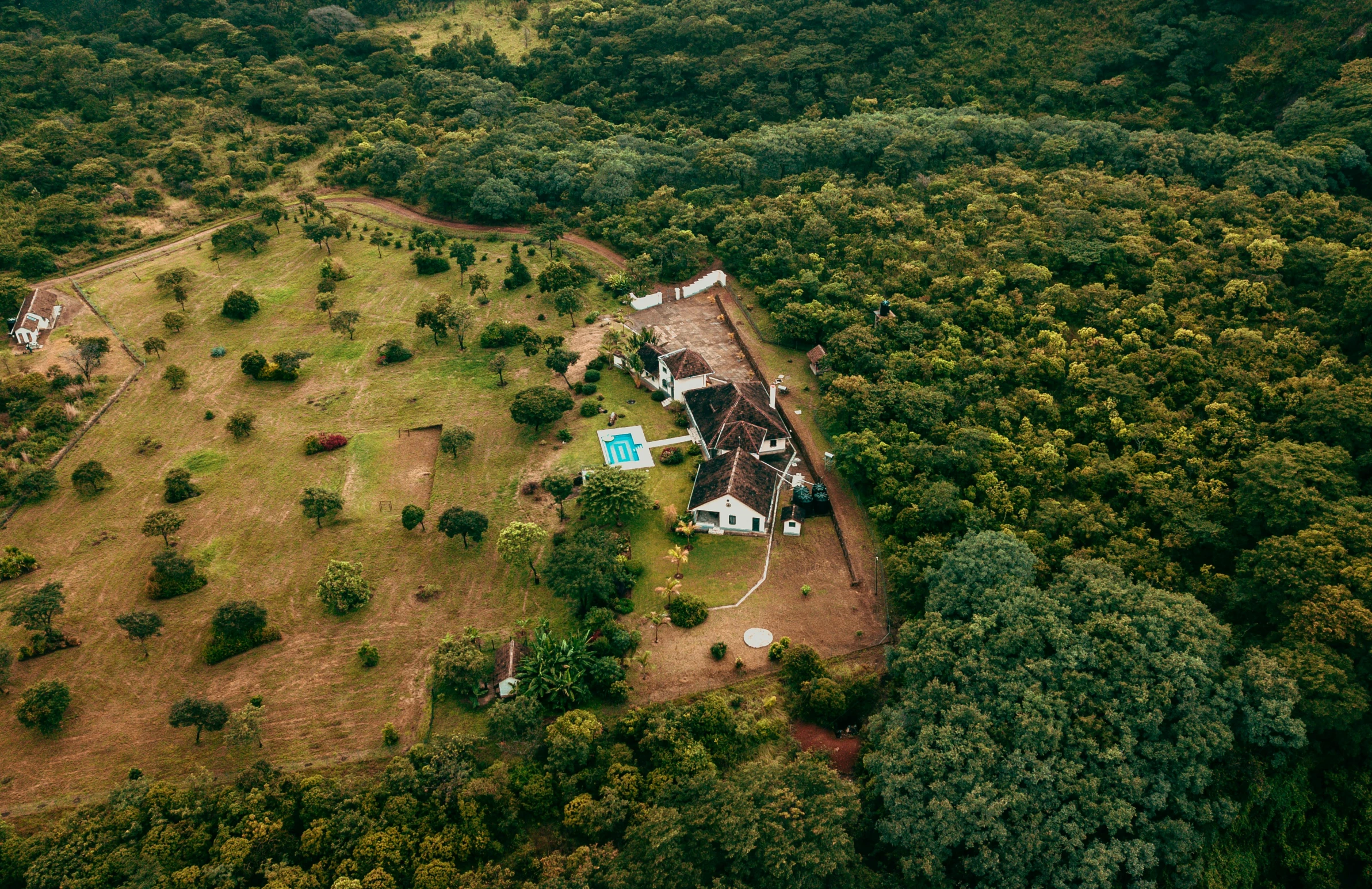 an aerial view of a house surrounded by trees, pexels contest winner, sri lankan landscape, an overgrown forest, rich estate, airplane view