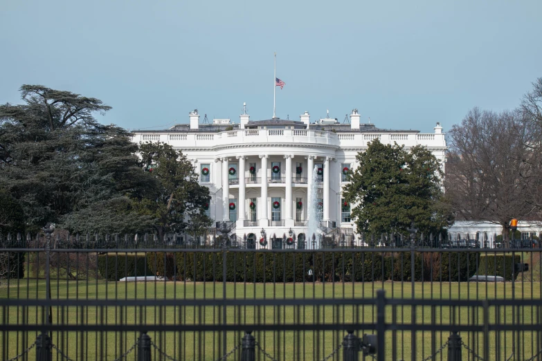 a view of the white house from behind a fence, slide show, politics, 2022 photograph, illustration »