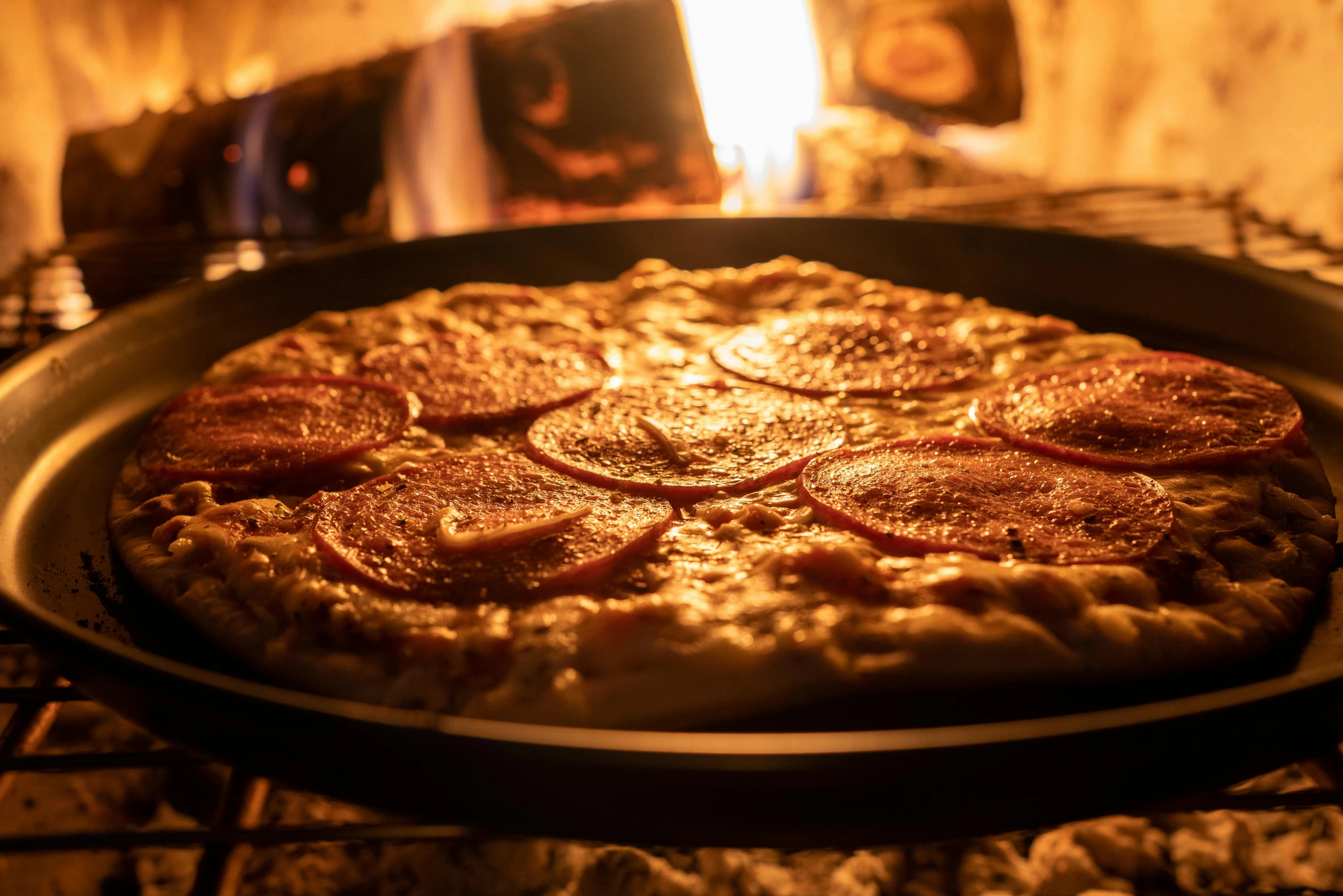 a pizza sitting on top of a pan in front of a fire, by Matt Cavotta, pexels contest winner, renaissance, profile image, low detailed, bottom angle, seasonal